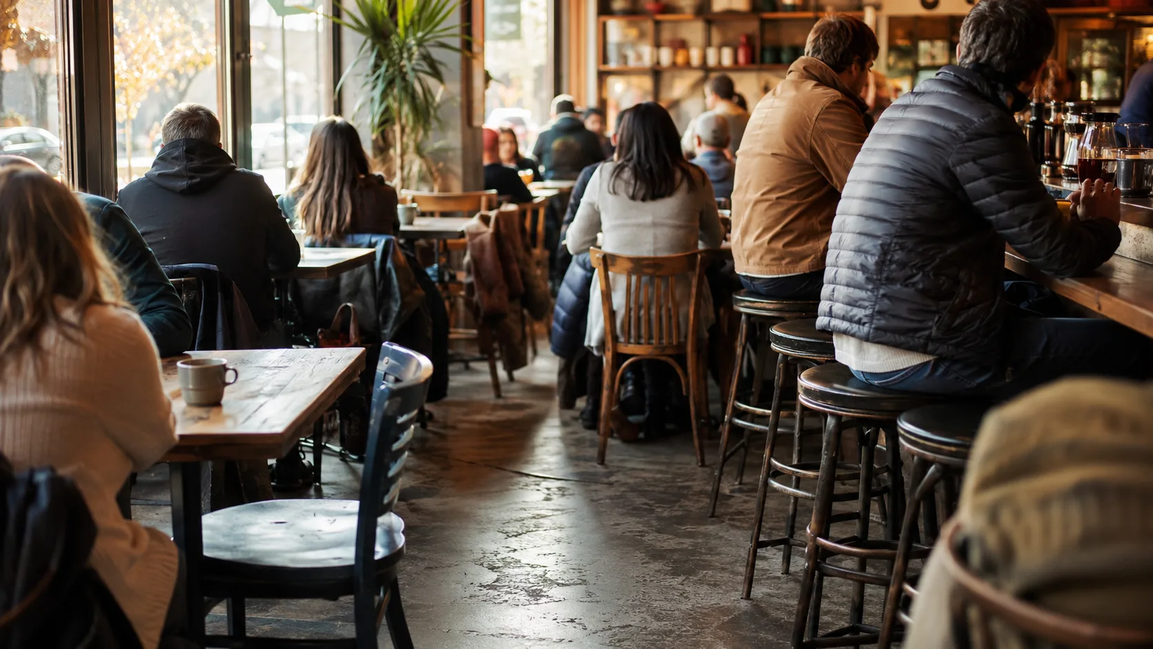 Coffee shop commercial seating in use showing morning service with multiple customers