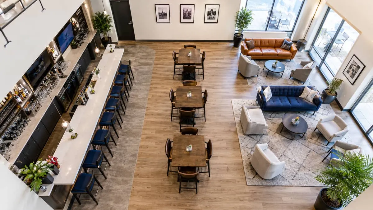 floor plan-style overhead view of a bar and lounge layout showing three distinct furniture zones: bar stool area at the 