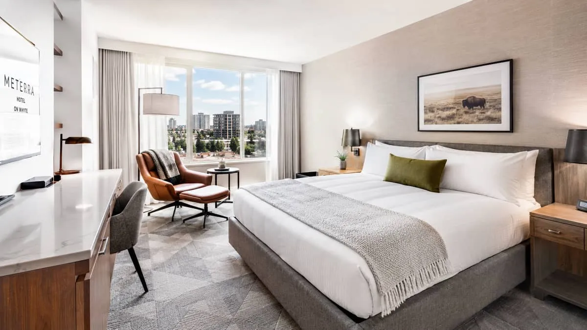 a boutique hotel room in an Edmonton property showing a well-edited mix of furniture pieces including an upholstered bed