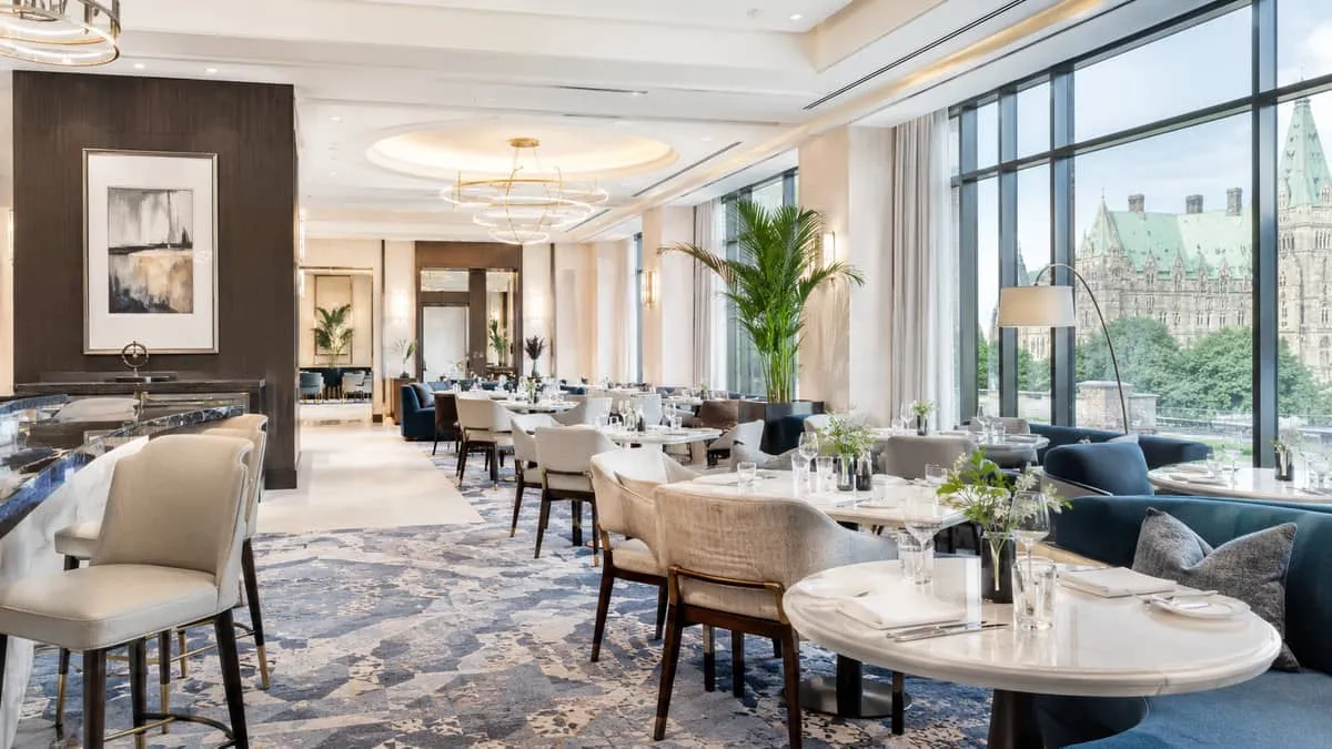 upscale Ottawa restaurant dining room or hotel lounge with contract-grade seating, warm lighting, and clean table settin