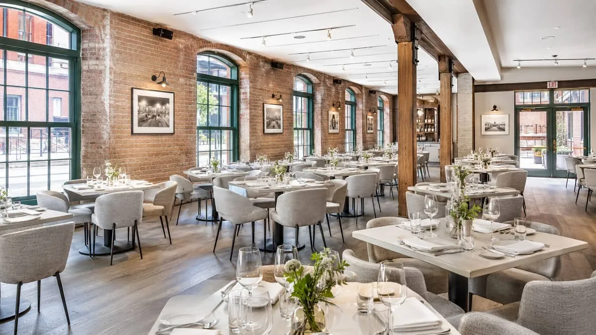 a restaurant dining room in a Toronto Distillery District venue with uniform seating and tables, showing the visual cohe
