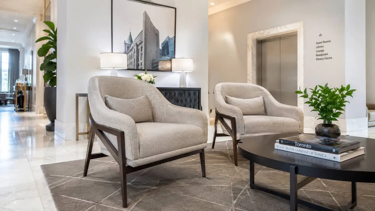 close-up of contract-grade lobby lounge chairs with visible quality detailing, tight upholstery, solid wood or metal leg