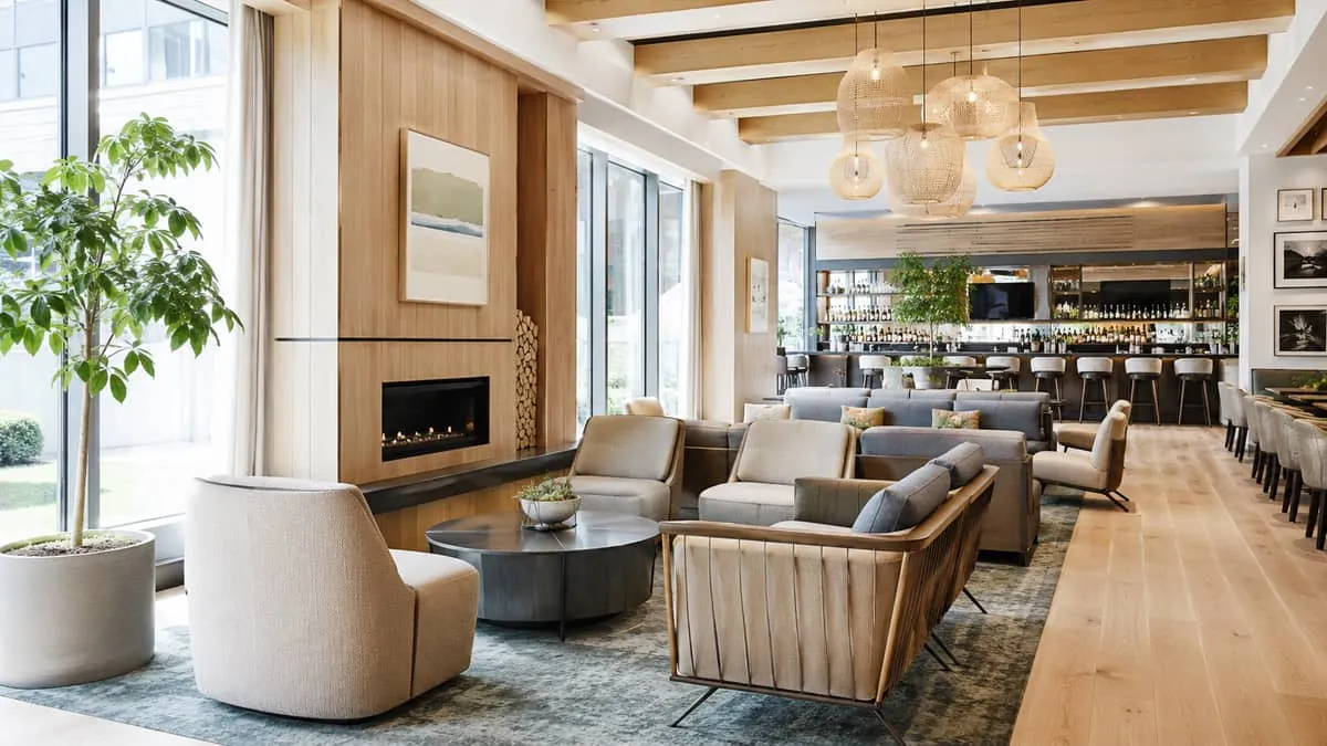 upscale lounge seating area in a Vancouver hotel bar or restaurant, showing natural wood tones, textured upholstery, and
