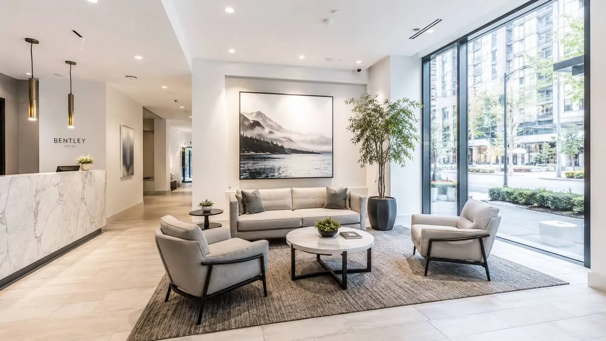 overhead or wide shot of a complete hotel lobby seating arrangement in Vancouver showing anchor lounge chairs, a sofa, s