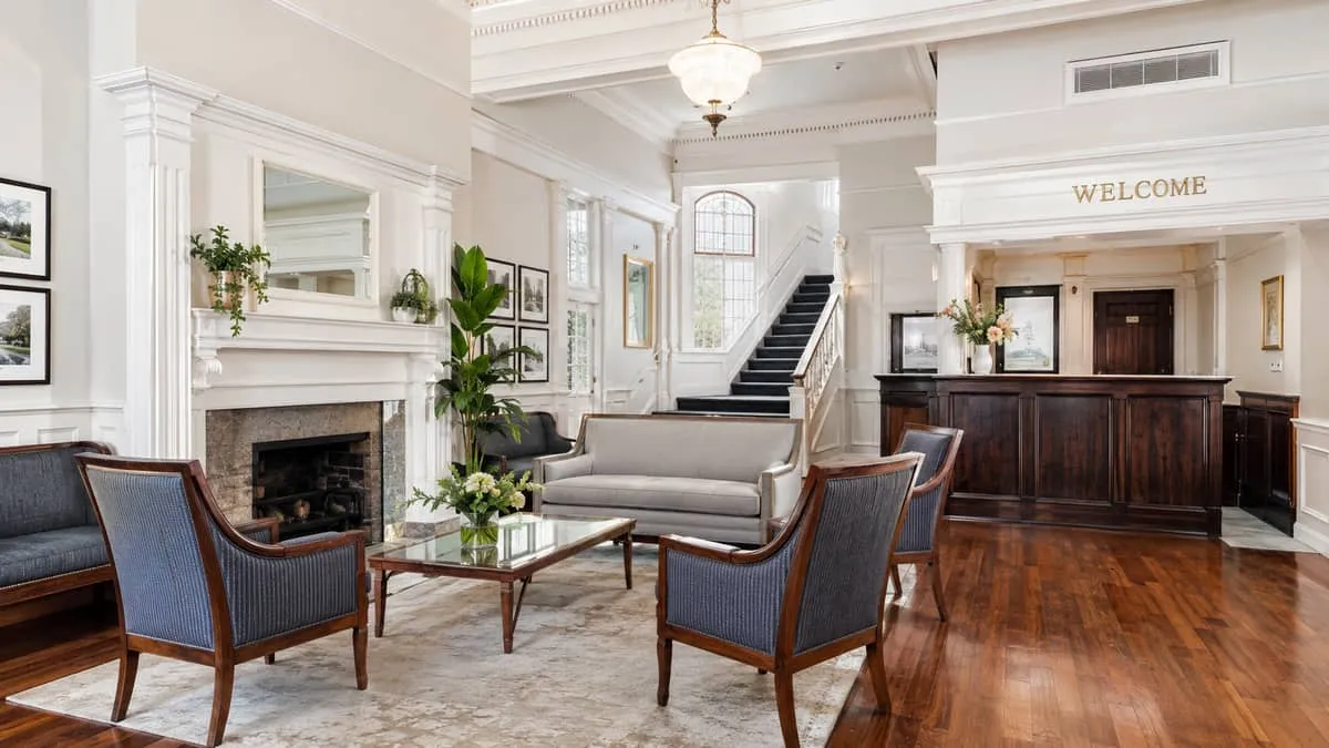 a heritage hotel lobby in Victoria BC's Old Town or James Bay neighbourhood showing period-appropriate furniture with ri