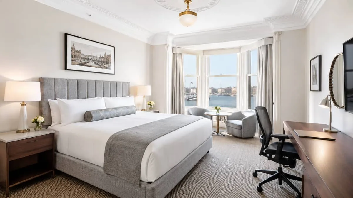finished boutique hotel room in a Victoria heritage building with warm lighting, newly installed contract-grade furnitur