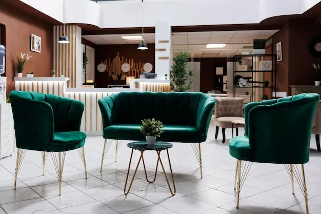 Hotel lounge seating area with ottomans and low tables near a reception desk