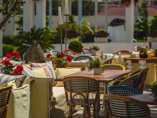 Commercial patio furniture with aluminum frames arranged on an outdoor deck