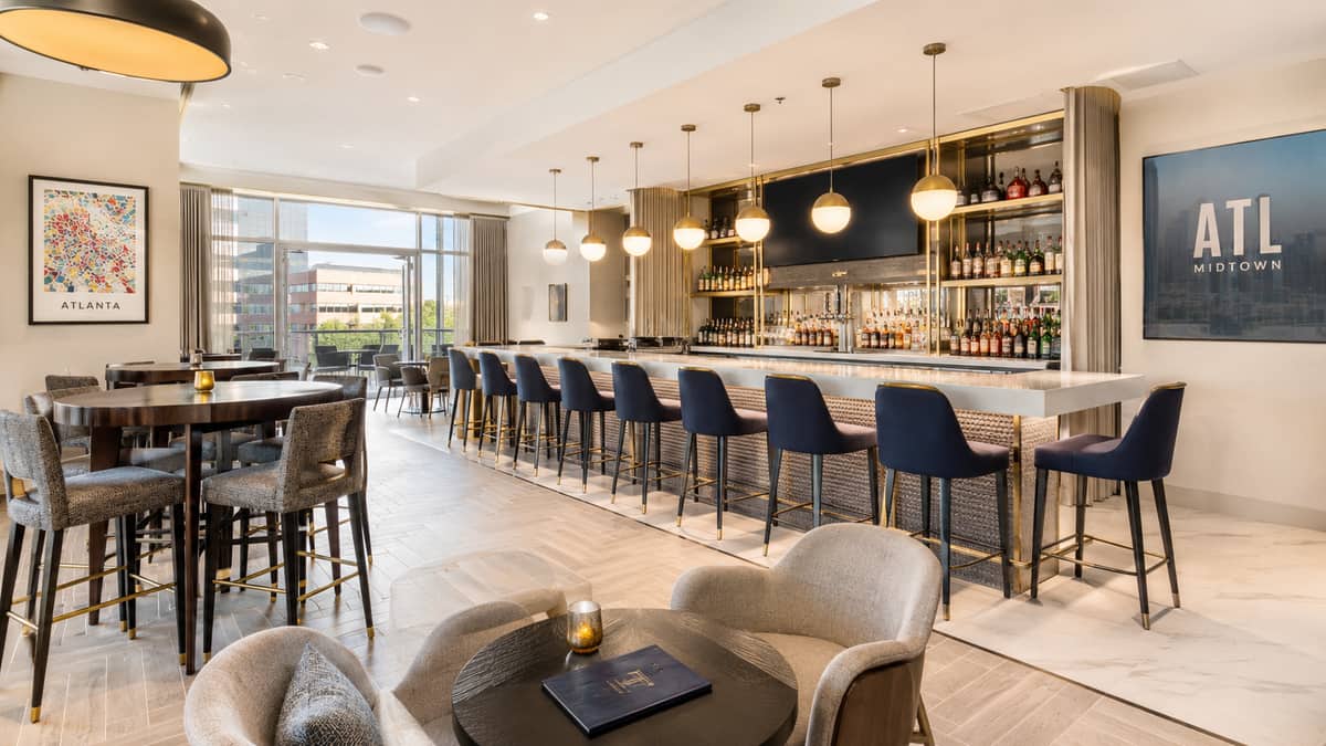 Downtown Augusta brewery and cocktail bar seating on Broad Street showing solid wood barstools with metal frame construction and durable upholstery