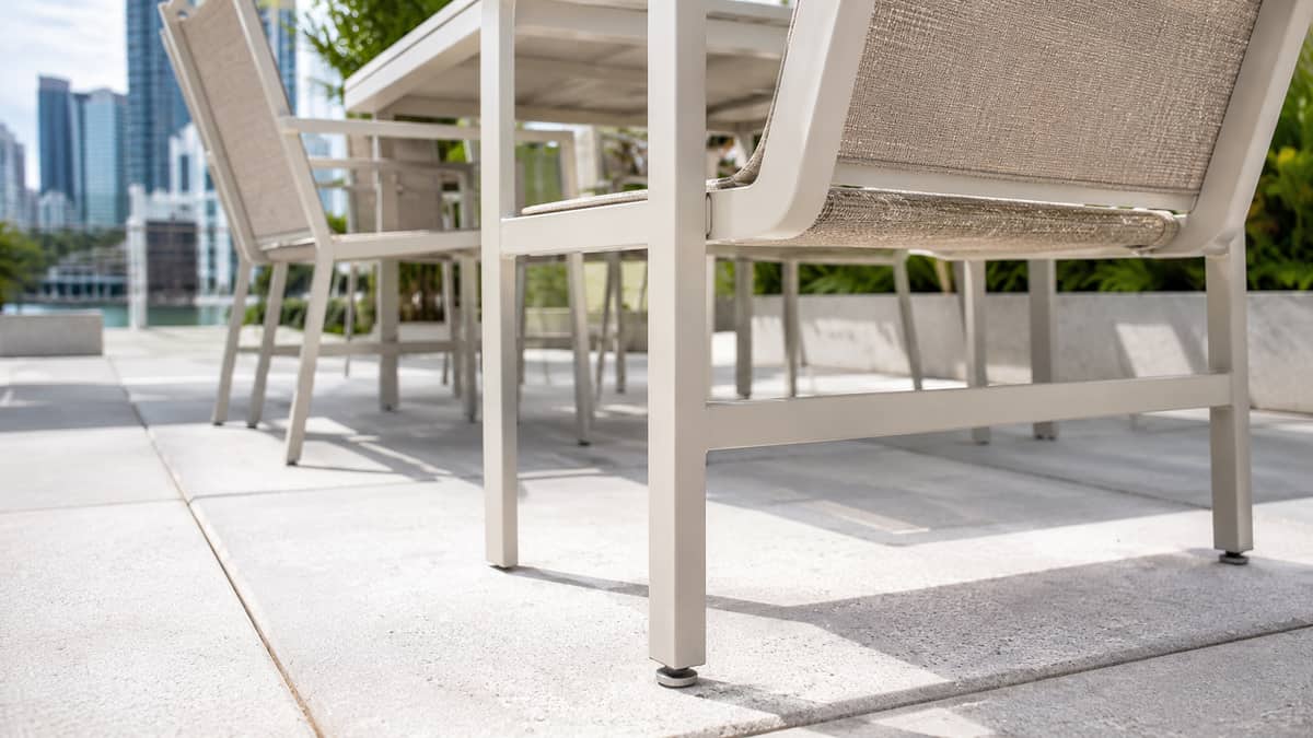 Recycled plastic and metal-frame picnic tables on a commercial patio