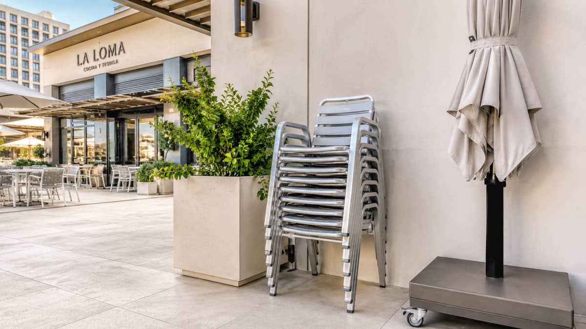 Commercial outdoor patio furniture with weather-resistant frame construction for a Dover restaurant or hotel terrace