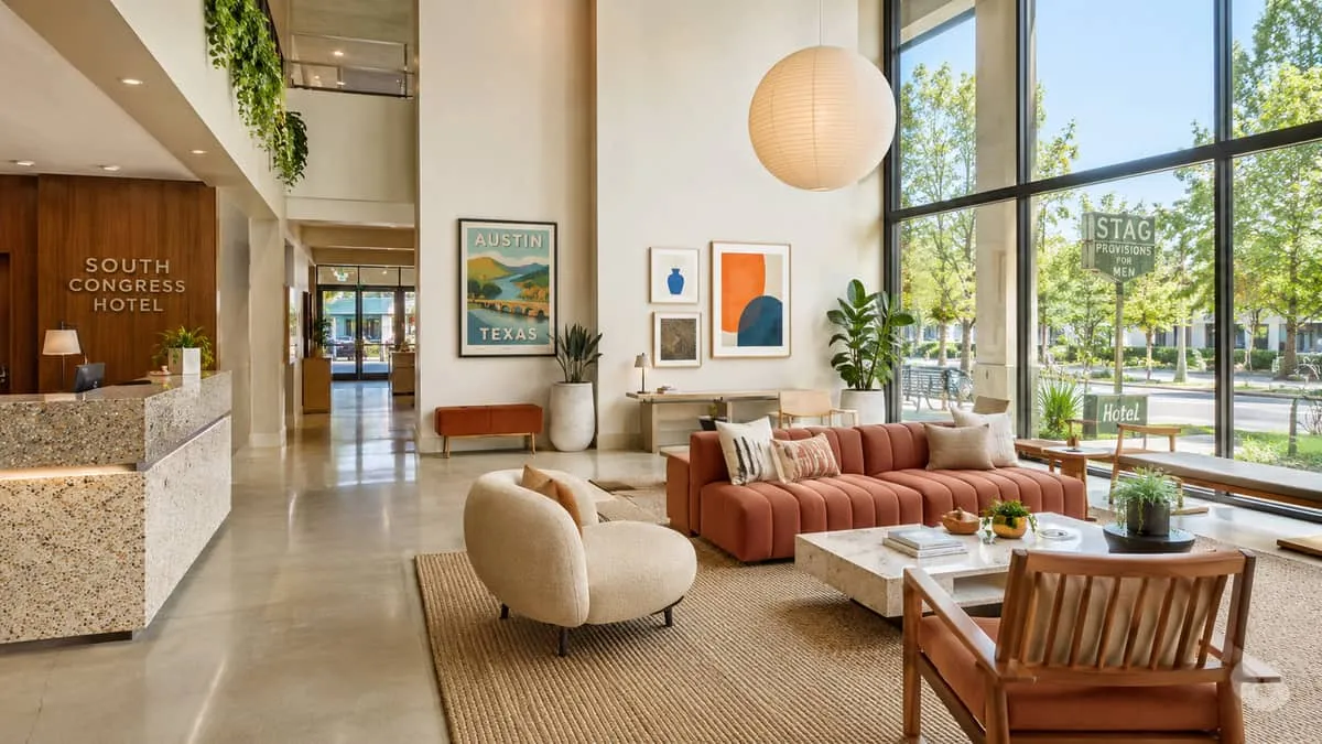 Atlanta hotel lobby chair with moisture-resistant performance upholstery and solid hardwood frame showing commercial construction detail for humid Southern climate