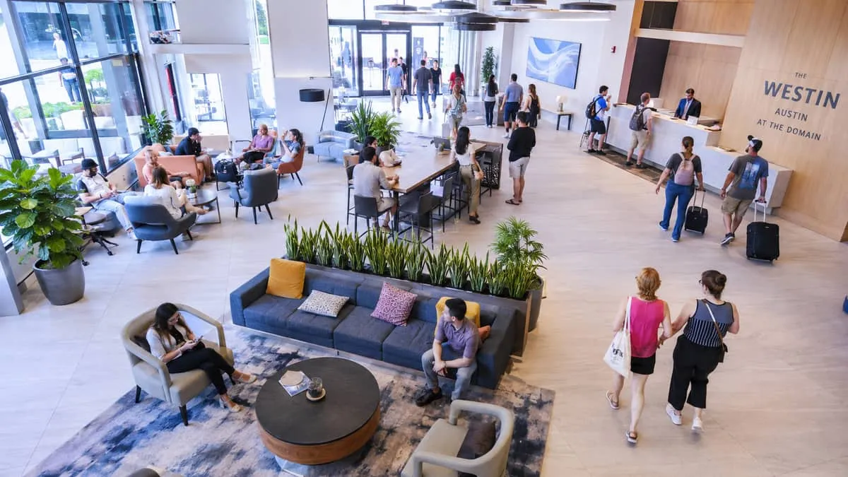 Completed hotel lobby furniture installation in Atlanta property showing full contract-grade seating program with coordinated side tables and lighting at opening