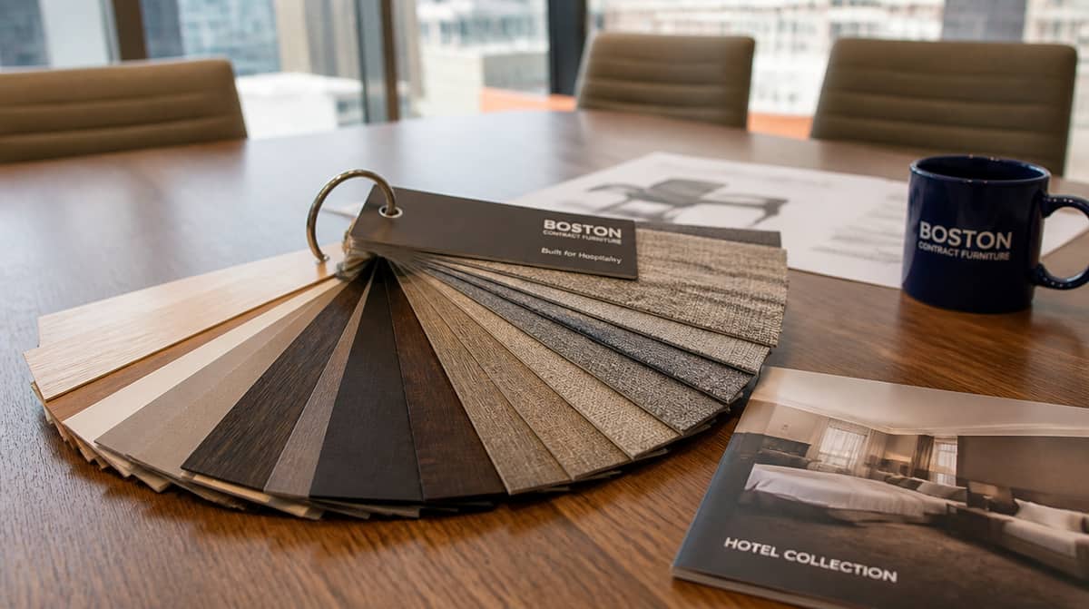 Interior design and FF&E procurement team reviewing furniture samples for Oklahoma City Bricktown hospitality project