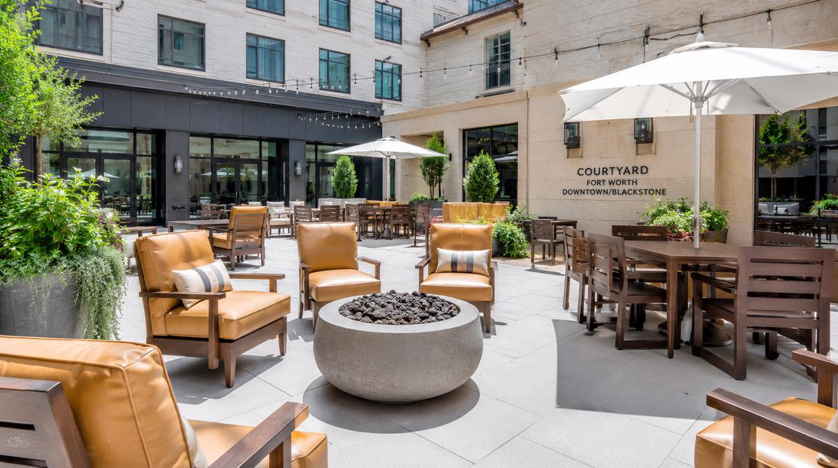 Commercial patio dining chairs with powder-coated aluminum frame suited for Jackson's humid summers and occasional winter ice, shown in a hospitality outdoor seating setup