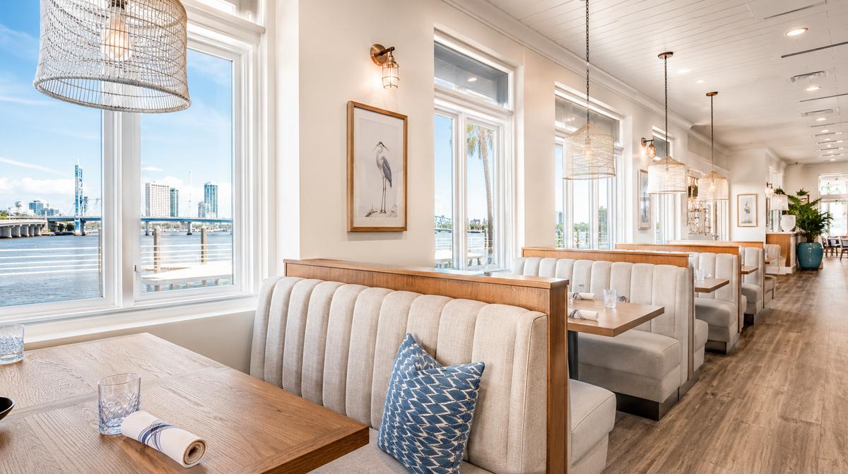 Restaurant patio furniture in a Manchester riverfront location showing powder-coated aluminum frames and solution-dyed acrylic cushions
